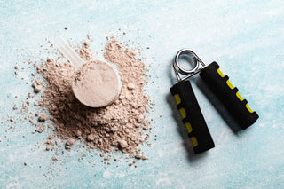 Protein powder and gym equipment on a blue background