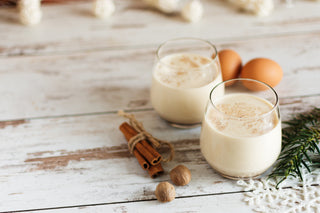 2 glasses of eggnog on a white background. 