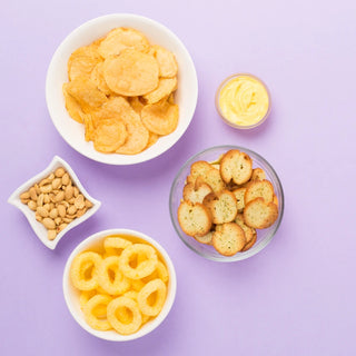 An assortment of snacks on a purple background