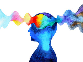 A watercolor painting shows a blue-toned human silhouette with a head filled with a spectrum of smoothly transitioning colors, resembling a brainwave