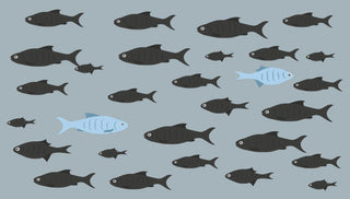 Illustration of many black fish swimming in various directions on a blue background. Among the black fish, three light blue fish stand out, swimming in different directions as well.